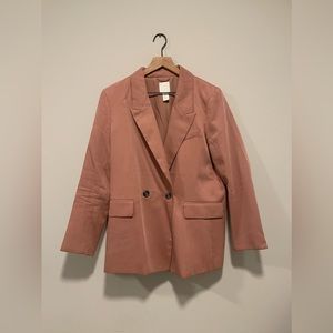Salmon colored Womens blazer.